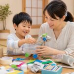 家庭で子供と一緒に不用品・ゴミをリサイクルしてクラフト工作している様子